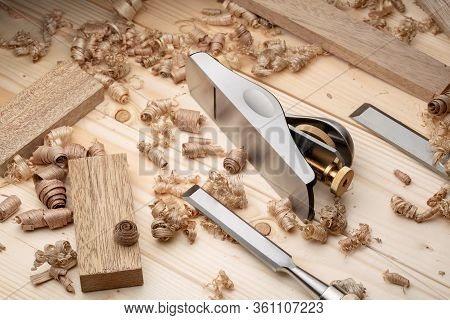 Chisel And Small Block Plane With Wood Shavings