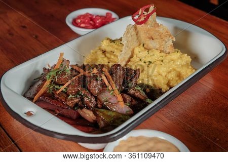 Peruvian Food Lomo Saltado :a Salted Beef With Tomatoes, Onion, Fried Potatoes And Rice. Risotto
