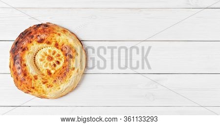 Tasty Fresh Round Tandoor Bread On A White Wooden Background. Flat Lay For Banner With Copy Space Fo