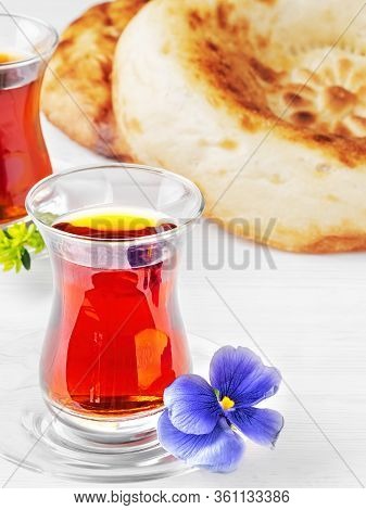 Tea In Glasses Of Armudu, Next To Two Freshly Baked Cake - Tandoor Bread, White Wooden Background. C