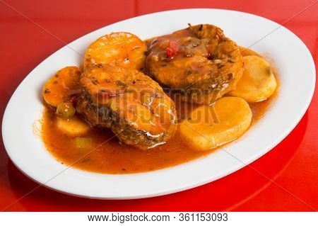 Cod Or Pollack Cooked In Tomato And Thyme Sauce.