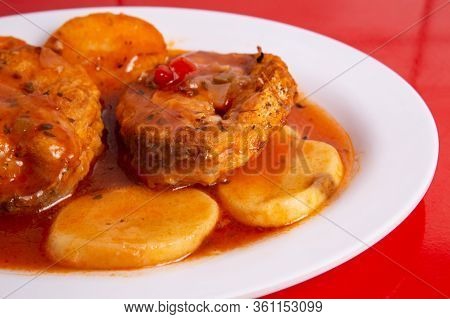 Cod Or Pollack Cooked In Tomato And Thyme Sauce.