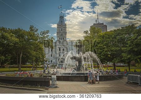 Quebec City, Quebec, July 2012 - Tourists Flocking Round The Fountain De Tourny Facing The Parliamen
