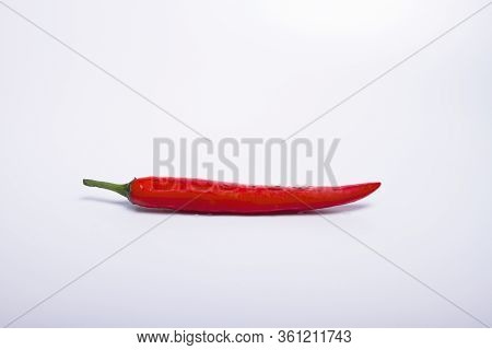 Fresh Red Chillies With Water Dripping On Seeds White Background
