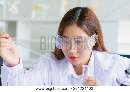 Doctor And Microbiologist With Vacuum Tubes For Samples With Covid 19 Infection Atypical Pneumonia V