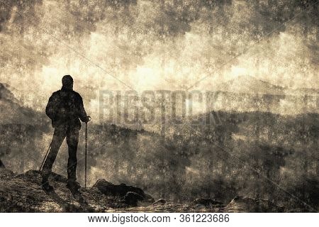 Discovery Travel Destination Concept. Hiker With Backpack Rises To The Mountain Top Against Backdrop