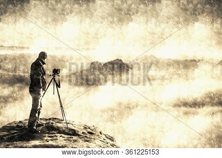 Landscape With A Man In Top Of A Peak Taking Photos With His Camera On The Stick At Sunset.  Calotyp