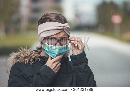 Woman With Facemask And Tarnished Glasses, Corona Concept