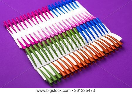 On A Purple Background Hair Clips Of Different Colors In Sets On A Cardboard Frame