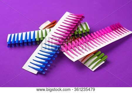 On A Purple Background Hair Clips Of Different Colors In Sets On A Cardboard Frame
