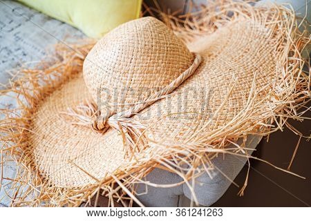 woman's strawhat on the sofa
