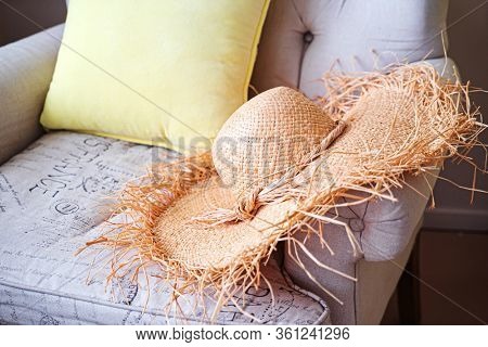 woman's strawhat on the sofa