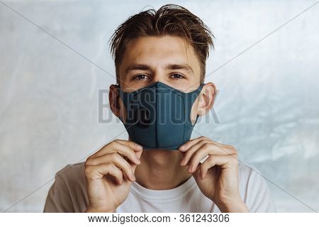 A Young Man Puts On A Protective Mask With A Filter