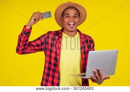 Afro Brazilian Man With Credit Card In Stusio On Yellow Background.farmer Taking A Loan In A Bank Fo
