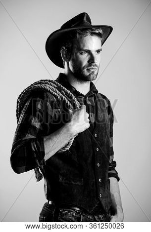 Man Wearing Hat Hold Rope. Ranch Occupations. Lasso Tool Of American Cowboy. Lasso Is Used In Rodeos