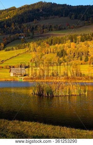autumn pond under the mountains, Murau district,
Styria, Austria