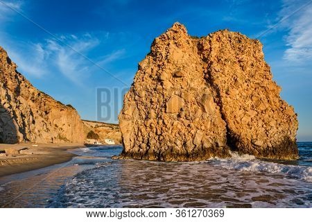 Fyriplaka beach and waves of Aegean sea on sunset, Milos island, Cyclades, Greece
