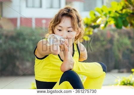 Happy Asian Armless Woman Warming Up Before Swimming At The Tropical Beach