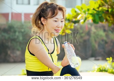 Happy Asian Armless Woman Warming Up Before Swimming At The Tropical Beach