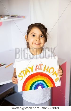 Stay At Home Due Coronavirus Pandemic Concept. Little Girl Paints A Rainbow On Stay At Home Poster. 