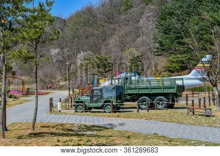 Hwanggan, South Korea; April 14, 2020: Military Jeep,truck And Fighter Jet On Display At No Gun Ri P