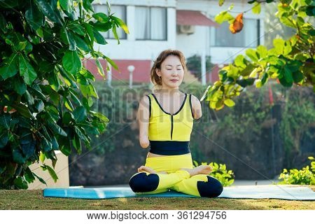 Happy Asian Armless Woman Warming Up Before Swimming At The Tropical Beach