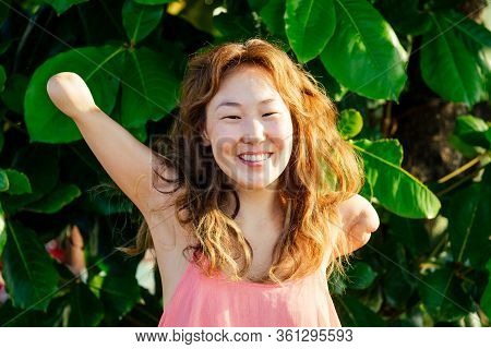 Happy Asian Armless Woman Smilimg At The Tropical Beach