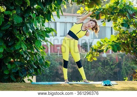 Happy Asian Armless Woman Warming Up Before Swimming At The Tropical Beach