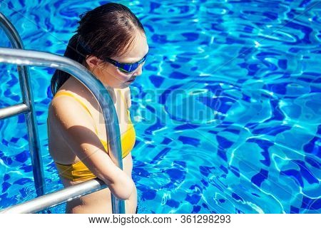 Happy Asian Armless Woman Warming Up Before Swimming At The Tropical Beach, She Jumps