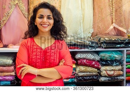 Indian Seller Women In Red Kurta Stand In Her Studio Showroom