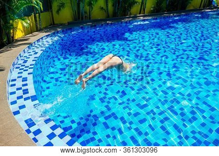 Beautiful Young Armless Woman Training To Swim In Pool At Tropical Resort