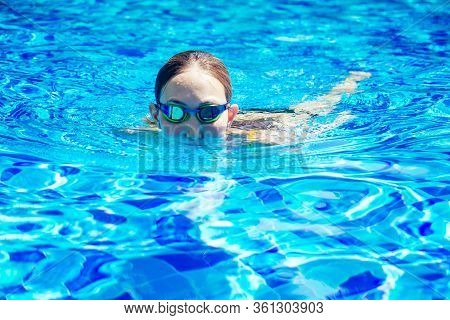Beautiful Young Armless Woman Training To Swim In Pool At Tropical Resort