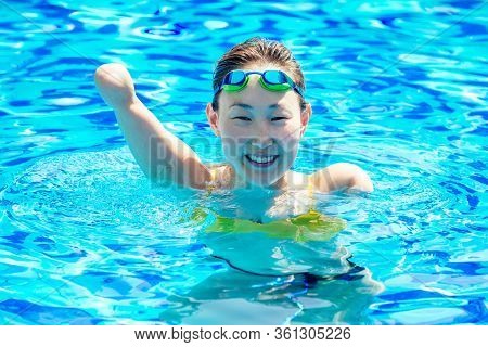 Happy Asian Armless Woman Warming Up Before Swimming At The Tropical Beach, She Jumps