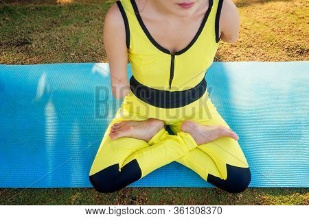 Happy Asian Armless Woman Warming Up Before Swimming At The Tropical Beach On Yoga Mat