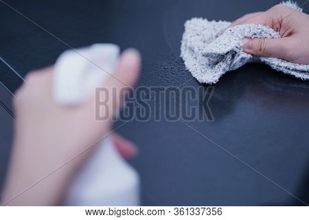 Young Woman Is Holding Spray Bottle, Rag To Clean, Wipe Down Office Metal Cabinet Shelf Accommodatio
