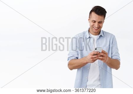 Communcation, Messaging And Online Lifestyle Concept. Cheerful Handsome Man Texting Friend, Chat Wit