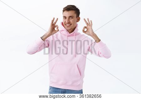Alright We Agree. Portrait Of Enthusiastic Handsome Caucasian Man, Show Okay Gesture, Rate Good Prod