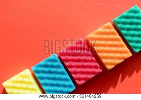 Brightly Colored Sponges On Red Background With Copy Space.cleanup Day.sponges Cleaning Kit .house C