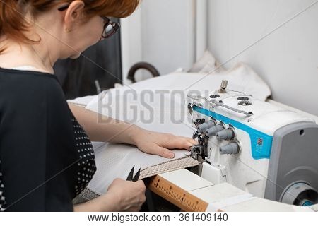 A Seamstress With Many Years Of Experience In Middle Age Works Quickly And Efficiently.