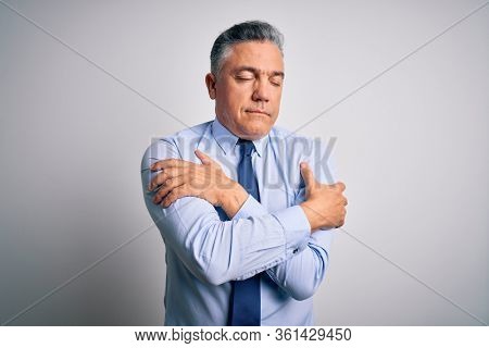 Middle age handsome grey-haired business man wearing elegant shirt and tie Hugging oneself happy and positive, smiling confident. Self love and self care