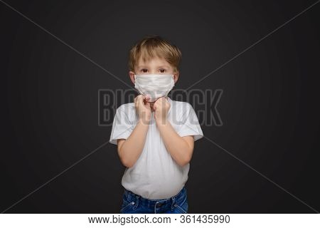 Five Year Old Boy On A Gray Studio Background In A Medical Mask