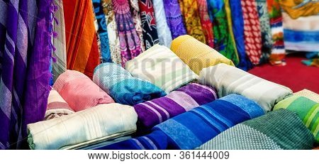 Many Oriental Style Blankets And Curtains On A Furnishing Market Stall