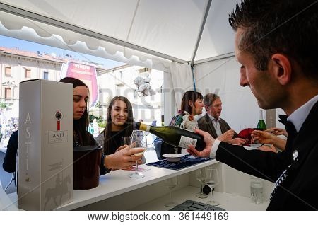 Alba, Italy - April 22, 2017 - Sommelier, And Young Women Tasting Asti And Moscato, Traditional Wine