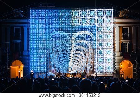 Cuneo, Italy - July 12, 2019: Crowd Looking A Light And Music Performance At Night During Cuneo Illu