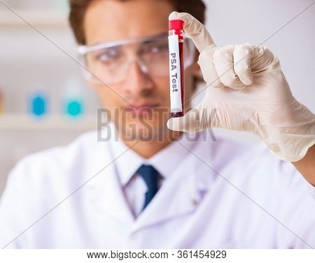 Young handsome lab assistant testing blood samples in hospital