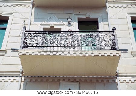 Window Balcony On A Stone Building . Elegant Decorative Old Stone Balcony. Low Level Perspective Of 