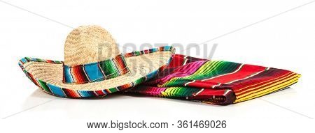 A woven Mexican sombrero or hat with a colorful serape blanket