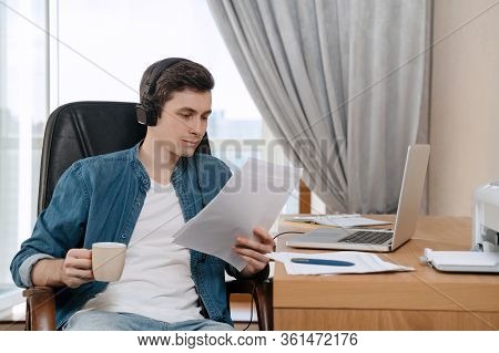 Happy Young Freelancer In Headphones Working Remotely From Home Office, Satisfied With Work Result, 