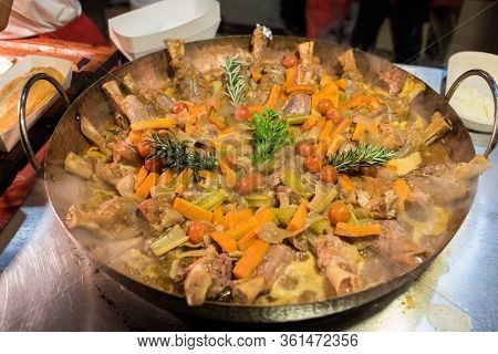 Delicious Lamb Stew In Large Cast Iron Pan. Real Life Street Food Restaurant Meal Preparation