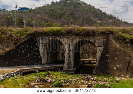 Railroad Arch Bridge In Hwanggan, South Korea With Circles And Triangles Marking Where Bullets Durin